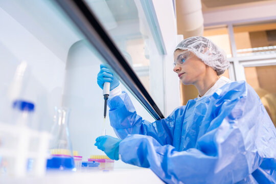 Medical Research Laboratory Portrait of a Beautiful Female Scientist in Goggles Using Micro Pipette for Test Analysis. Advanced Scientific Lab for Medicine, Biotechnology, Microbiology Development