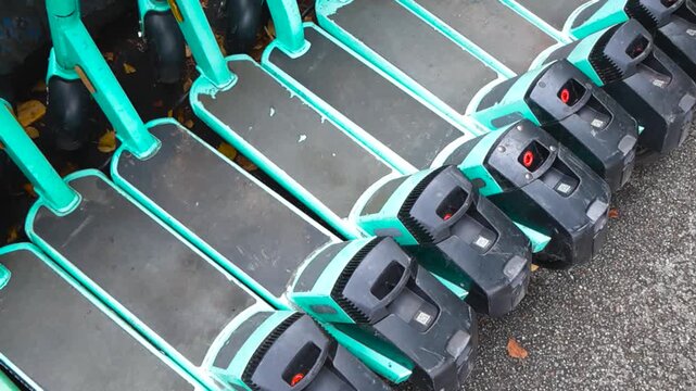 Modern electric scooters available for rent parked in a row, a convenient urban mobility solution for city transportation and reducing traffic congestion with zero emissions and clean energy