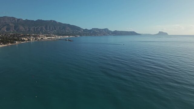 Enjoy the sunny views of the Costa Blanca coastline along the Mediterranean Sea. See the beach and mountains around Albir and Altea in Spain.