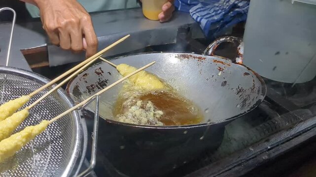 Traditional Indonesian street food vendor cooking telur gulung egg roll snack
