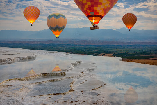 Hot air balloon flying over spectacular pamukkale - Natural travertine pools and terraces in Pamukkale. Cotton castle in southwestern Turkey,