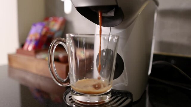 Fresh Espresso Pouring into Glass Mug from Coffee Machine
