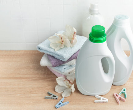 Laundry detergent and fabric softener bottles with fresh towels