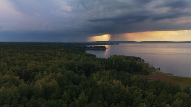 Rain over the lake. Aerial timelapse of the stormy clouds forming in the sky and rain falling on the horizon. The Kama river, Russia