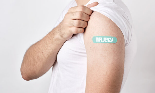 Man showing his arm with influenza vaccine plaster