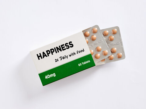 Happiness pills coming out of their box on white background