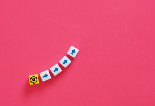 Blocks with upwards arrows coming out of a yellow block with product or production symbol indicating successful product launch.