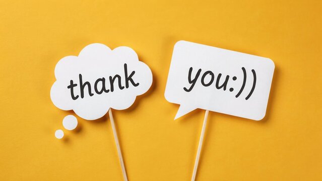 Thank you message on speech bubble signs against a yellow background