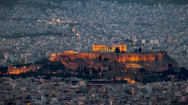 Day to night time lapse view of the Parthenon Temple at the Acropolis of Athens, Greece, within the urban skyline of the city