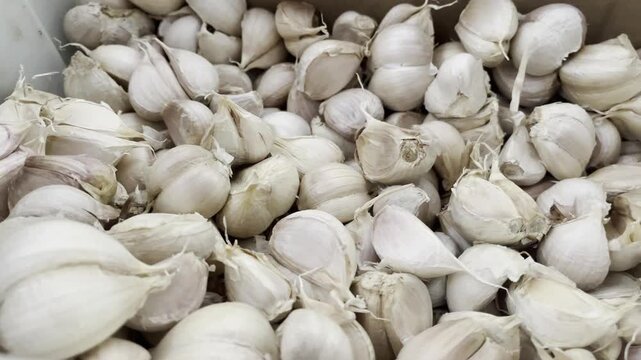 Fresh raw garlic cloves pile close up food background