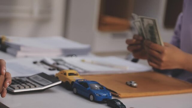 Car sale or rental concept, Closeup Dealership manager signing car insurance document or lease paper contract. Customer with car dealer agent making deal, sign on agreement document contract in office