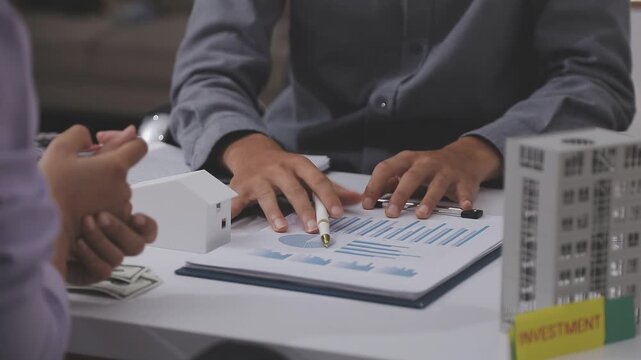 Business professionals meet with real estate agents to discuss real estate investments, sign contracts, apply for mortgages, plan purchases, ownership, and successfully secure approval for