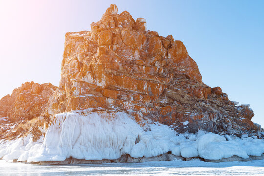 Scenic view of Shaman Rock Shamanka covered with ice and snow on the frozen shore of Lake Baikal, Olkhon Island, Irkutsk Oblast, Russia on a clear day
