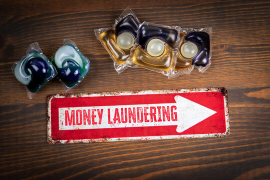 MONEY LAUNDERING Concept With Detergent Pods and Directional Arrow Sign