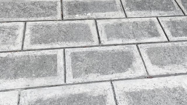 Top view of grey rectangular paving blocks texture background layout