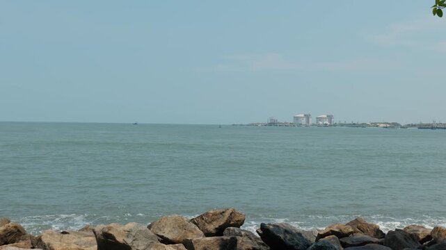 Sea with waves and buildings at long at sunny day in Fort Kochi, Kerala