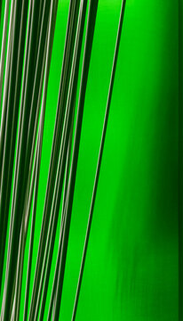 Closeup of vertical rods with striped pattern on green background