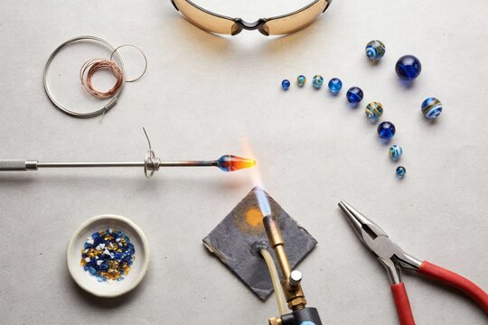 Lampwork bead being shaped in a torch flame