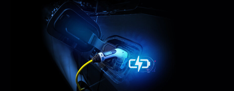 Power cable pump plug in charging power to electric vehicle EV car.