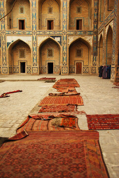 Arched entrance with carpets in the courtyard, Bukhara, Uzbekistan
