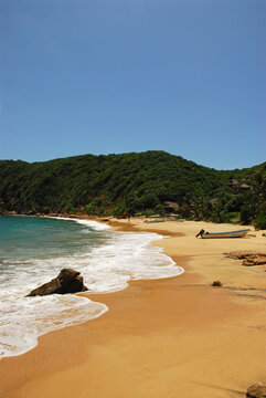 Scenic view of a beach below mountains and houses, Mazunte, Mexico