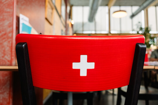 Swiss flag design on chair in modern furniture setting