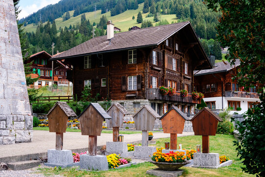 Cemetery in Swiss village with wooden structures and flowers