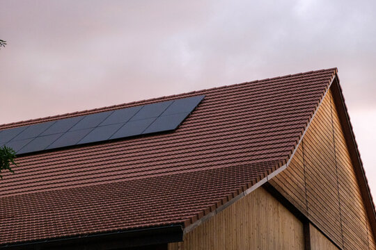 Modern solar panels on the roof of a barn