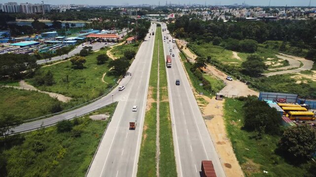4K aerial view of traffic on the Bengaluru&ndash;Mysuru Expressway in Karnataka, India, showcasing modern highway infrastructure, divided carriageways, and surrounding urban development.
