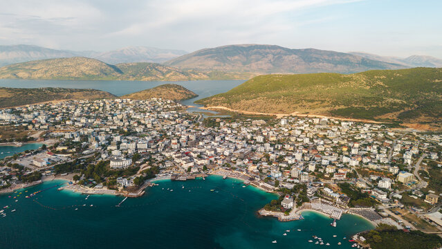 Aerial view of coastal town and turquoise bay in Albania