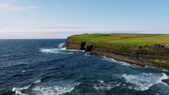 Aerial view of Dun Briste Sea Stack with rugged cliffs and Atlantic Ocean waves crashing against the coast in Ballycastle, County Mayo, Ireland.