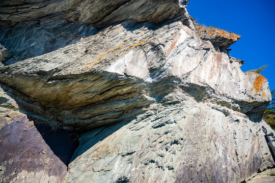 Ancient petroglyphs carved into rock at Tomskaya Pisanitsa in Siberia. Prehistoric rock art represents archaeological heritage and early human culture