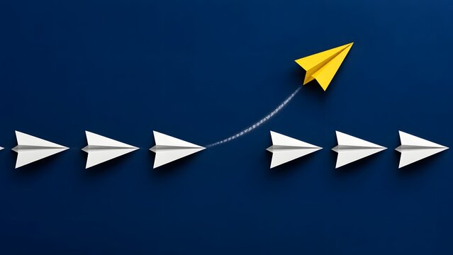 Yellow paper airplane leaving formation and flying upward away from row of white paper planes on dark blue background, symbolizing leadership, standing out and individuality