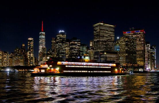 A vibrant sunset panorama of Manhattan downtown skyline, viewed from the river