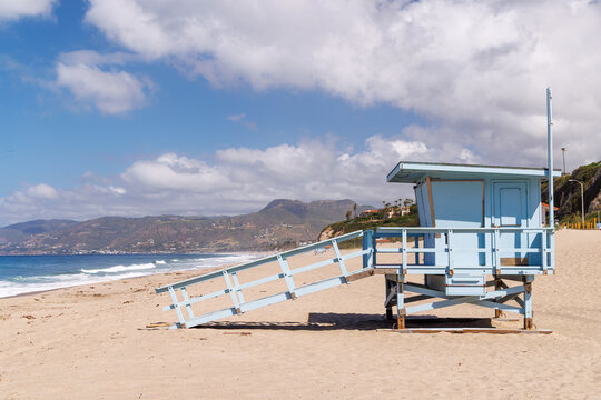 Lifeguard tower on a California ocean beach with golden sand and waves