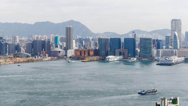 Hong Kong skyscraper panorama on a sunny day with water and boats