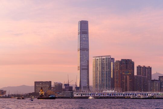 Hong Kong city skyline at sunset with glowing sky and skyscrapers