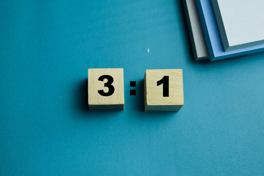 Three to one ratio text stacked wooden cubes on the table. For mathematical composition and finance