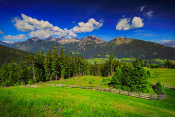 Alpine mountain panorama above a green meadow © Tom Pavlasek