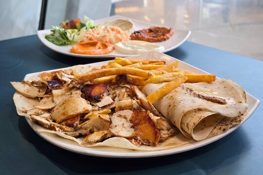 Middle Eastern Chicken Shawarma Platter Served with French Fries and Flatbread.
