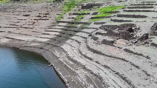 Extremely low water levels exposing ancient terraces at Belesar dam