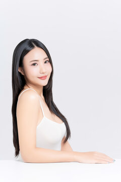 Happy young Asian woman with beauty face natural makeup and healthy black hair isolated on white background, for a perfectly woman, self care, cosmetics and wellness concept.