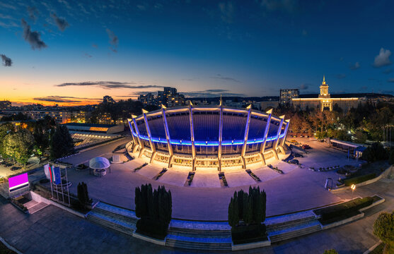 Illuminated Palace of Culture and Sports and Nikola Vaptsarov Naval Academy in Varna at dusk