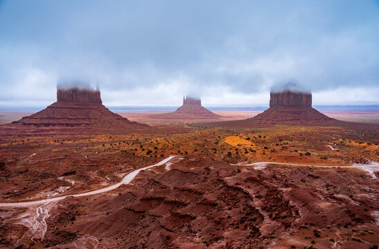 Sandstone buttes rising through fog, Monument Valley Tribal Park, Arizona, USA