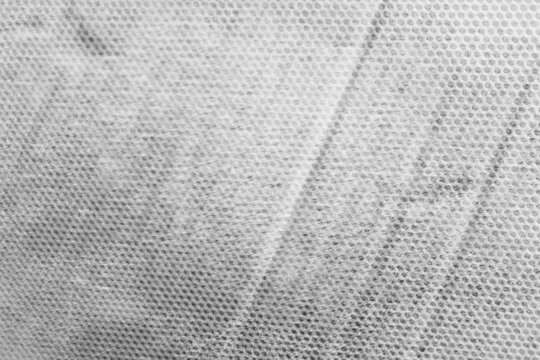 Light monochrome mesh texture with subtle diagonal fold. Bright white and grey grid pattern. Perfect minimal high-key background for digital and print design.   