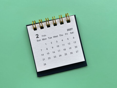 Minimal February 2027 desk calendar against a bright green background, featuring a clean monthly layout for planning, scheduling, organization, and time management.