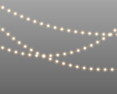 Softly glowing string lights suspended on thin wires create a warm and inviting atmosphere. The bulbs emit a gentle yellow glow grouped closely in curved horizontal rows.