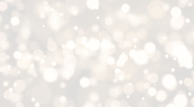 Diffuse golden bokeh lights create a warm and soft shimmering effect. The circular light spots vary in size and density across the dark background. This glowing pattern adds an elegant.