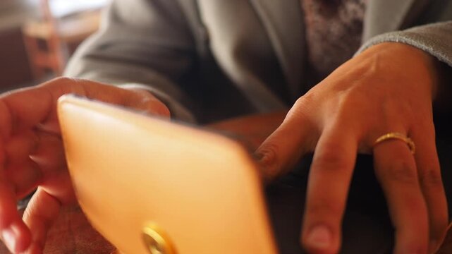 Close up of woman's hands taking money out of wallet, then closing it, dynamic footage with shallow depth of field, financial transaction concept.
