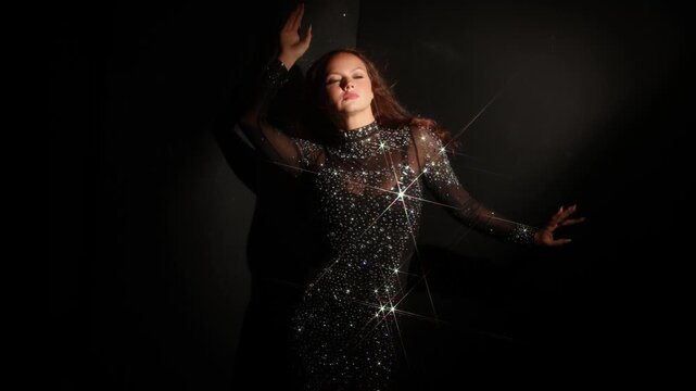 Star filter light effect on a crystal dress. A single bright burst spreads coloured rays across the frame, an example of creative optical lighting.